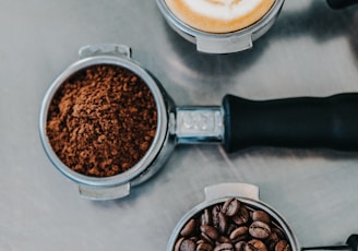 flat lay photography of coffee latte, ground coffee, and coffee beans