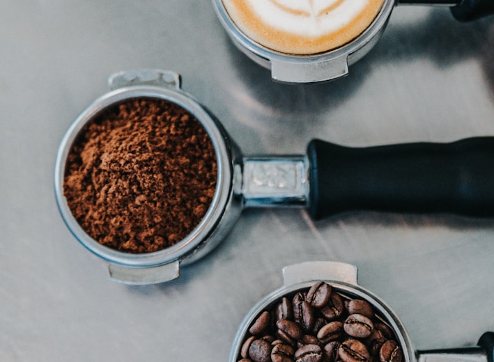 flat lay photography of coffee latte, ground coffee, and coffee beans