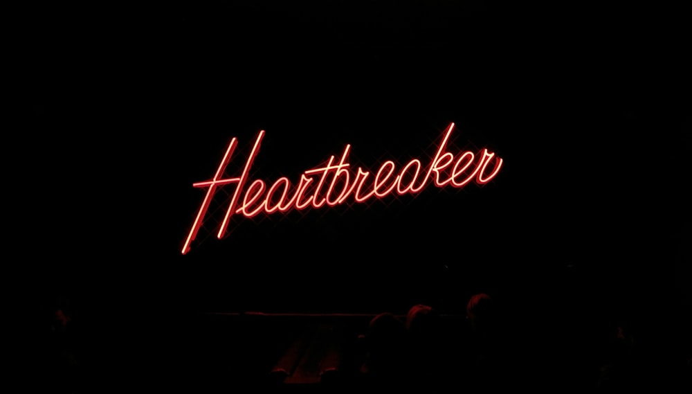 Heartbreaker neon signage on black background
