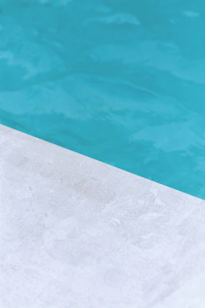 Close-up of a pool edge with fine detailing in anthracite gray and cobalt blue accents.
