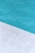A close-up view of a pool with clear blue water and a corner of light gray stone or concrete coping. The contrast between the water and the poolside creates a clean, refreshing look.