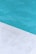 A close-up view of a pool with clear blue water and a corner of light gray stone or concrete coping. The contrast between the water and the poolside creates a clean, refreshing look.