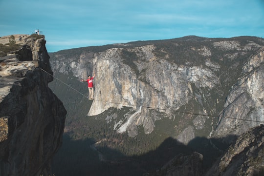 person standing on rope in Yosemite National Park, Taft Point United States
