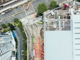 Aerial view of multiple cargo trucks moving on a busy road.