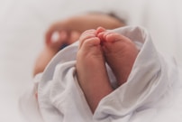 baby covered with white blanket