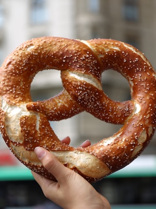 person holding pretzel