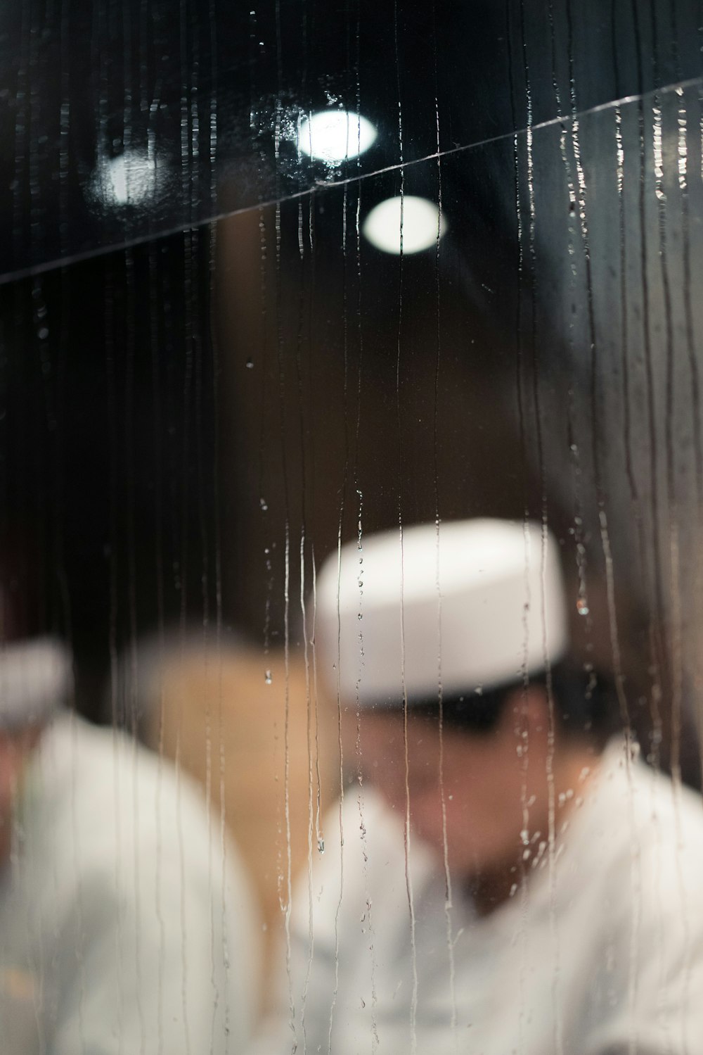 chef reflected on wet mirror