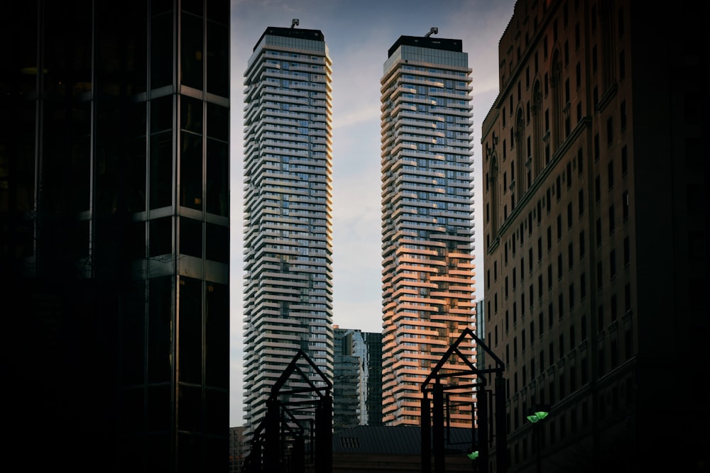 two gray concrete high-rise building at daytime