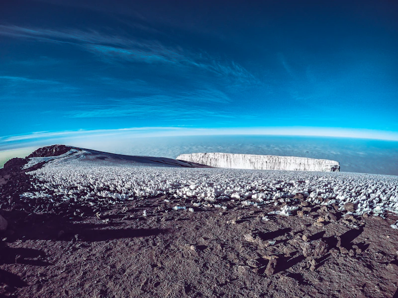 The snow-capped summit of Mount Kilimanjaro rising high above the clouds, Tanzania