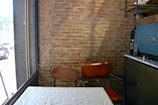 Interior view showing exposed brick walls in a cozy room.