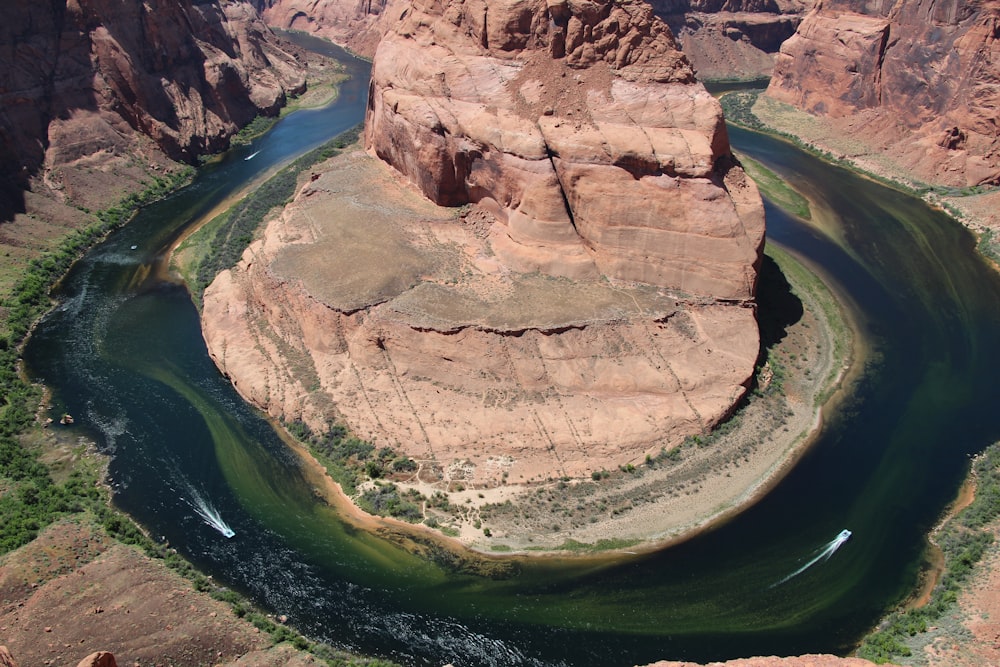 aerial photography of rock formation surrounded by river