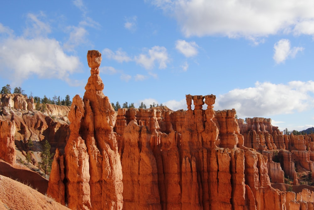 aerial photography of rock formation under cloudy blue sky at daytime