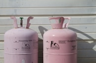 two pink Dynatemp 410 tanks on front of white wall