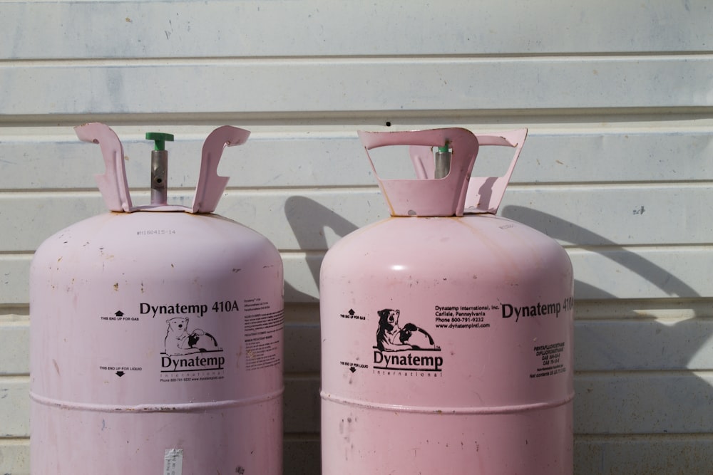two pink Dynatemp 410 tanks on front of white wall