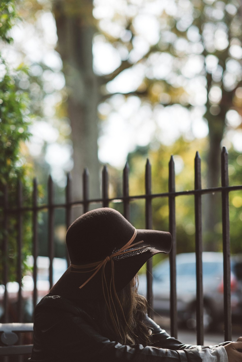 woman looking through the fence during daytime