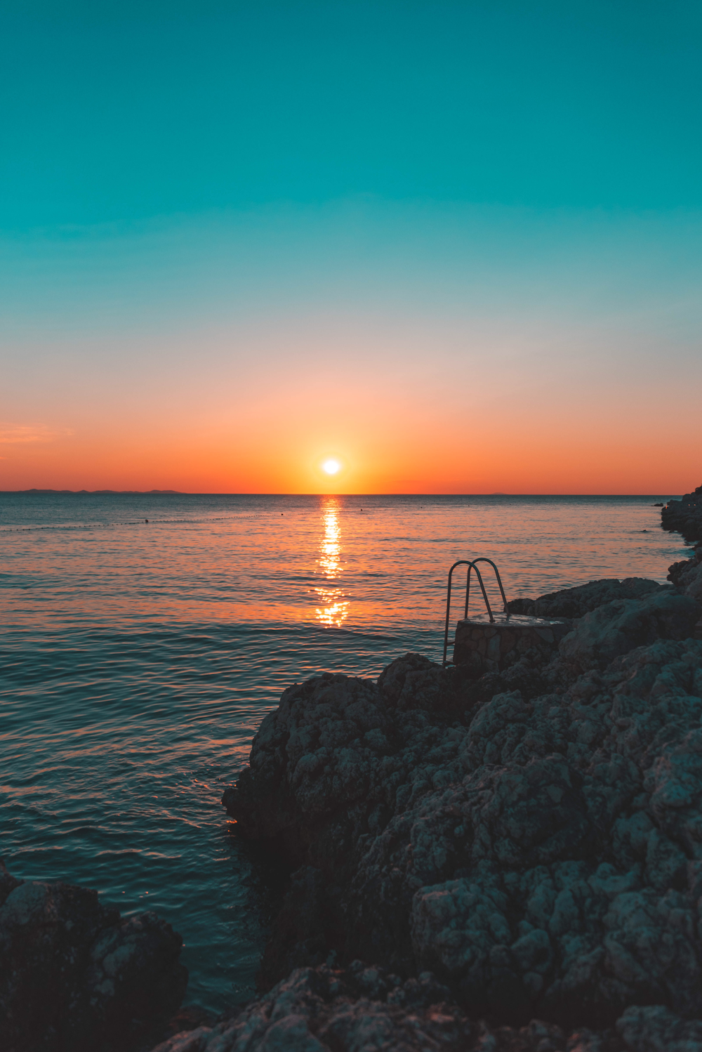 seashore under green sky during golden hour