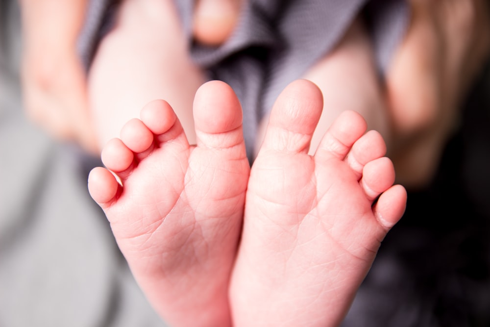 person holding baby's feet