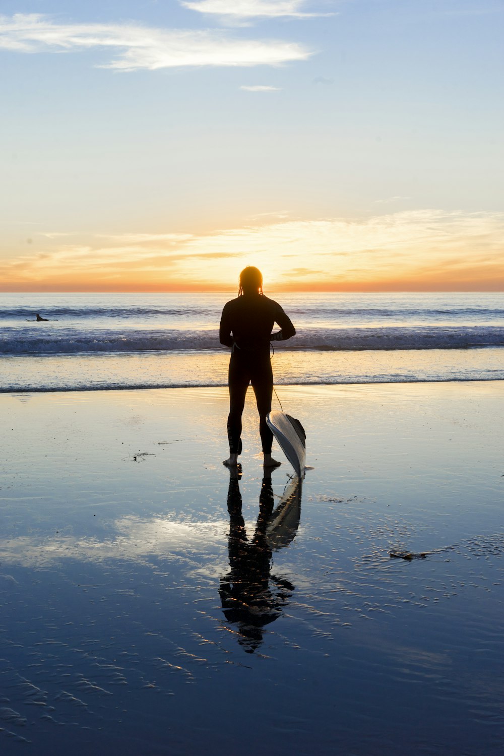 silhouette of man beside body of water