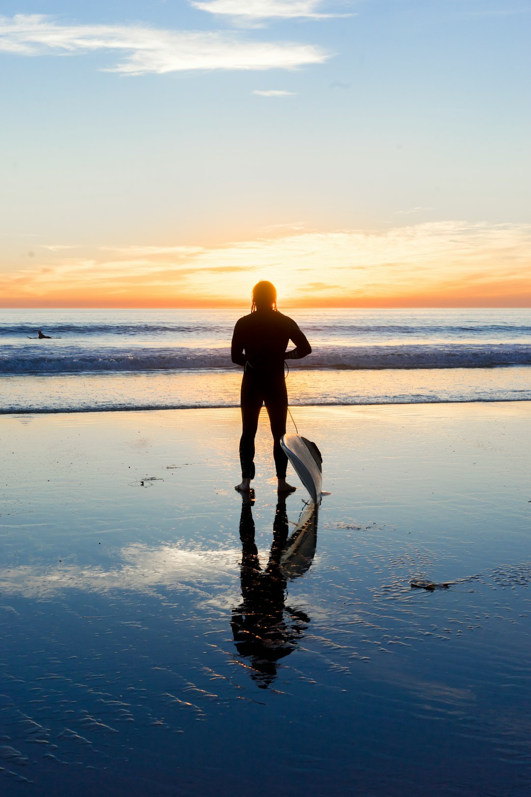 silhouette of man beside body of water