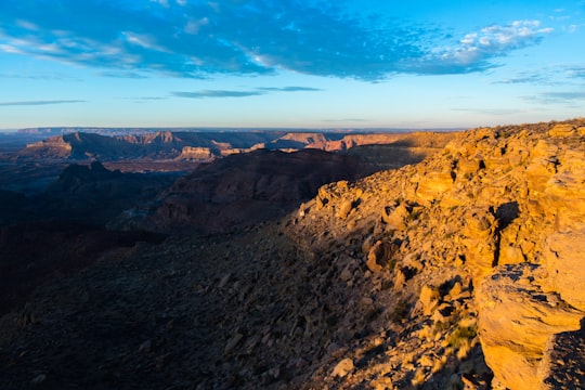 brown and green mountains under blue sky during daytime in Grand Staircase-Escalante National Monument United States