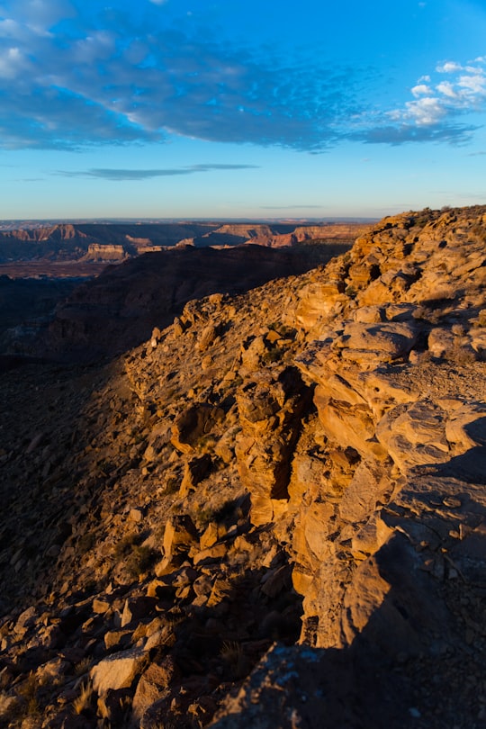 brown rocky mountain under blue sky during daytime in Grand Staircase-Escalante National Monument United States