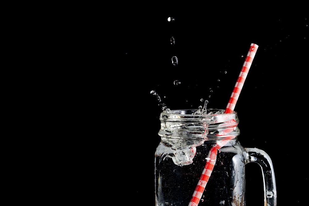 clear glass mason jar with straw