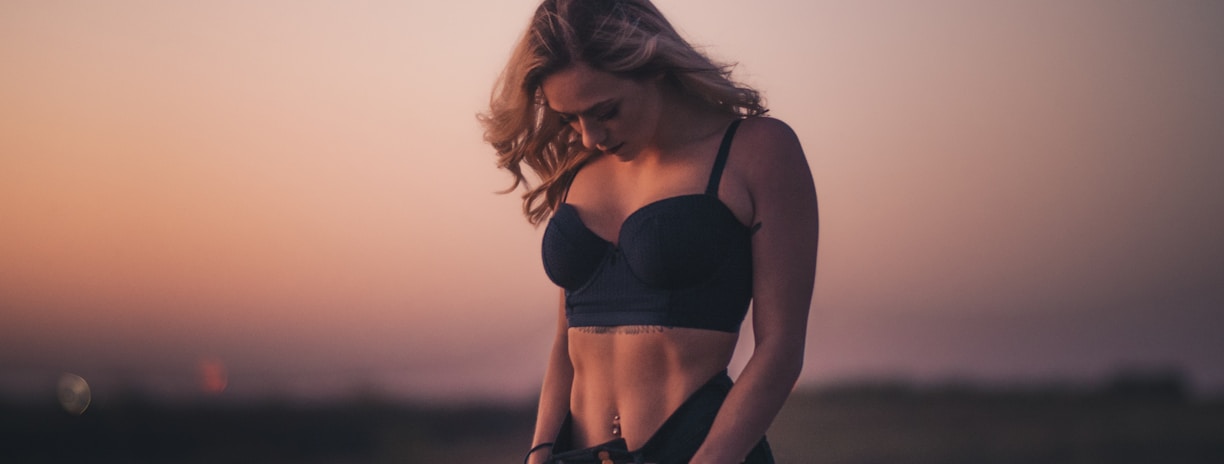 woman standing on the field during sunset