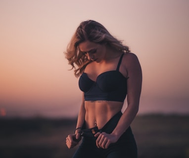 woman standing on the field during sunset