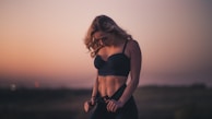 woman standing on the field during sunset