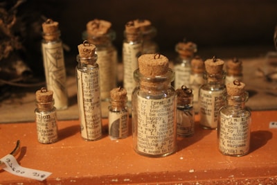 A collection of small glass bottles filled with colorful intention-infused oils.