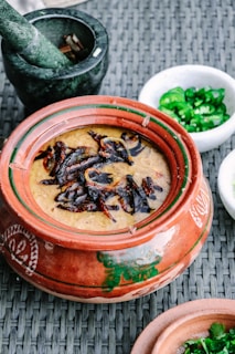 Traditional cooking setup with a clay pot and spices.