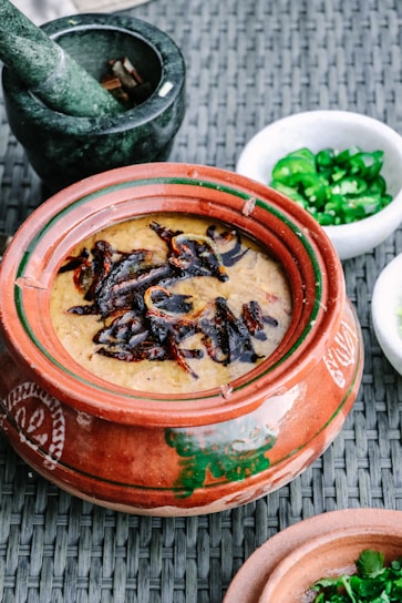 Close-up of a traditional clay pot filled with melted ghee.