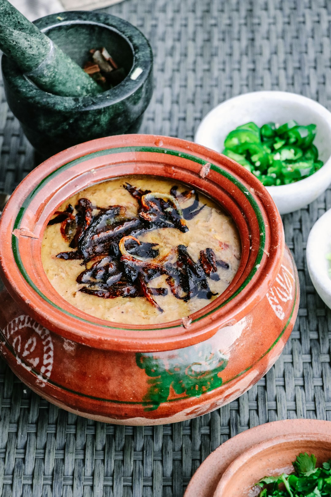  brown and black dish in ceramic pot pestle