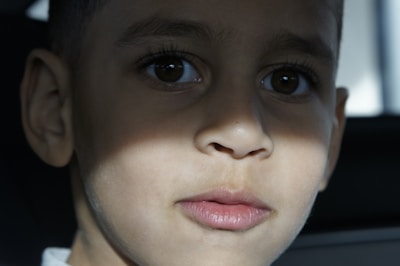 Close-up portrait of a child with soft natural lighting capturing innocence and curiosity.