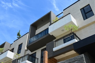 Modern residential building exterior with blue accents in a serene neighborhood.