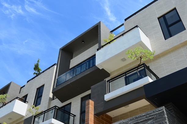 Modern residential building exterior with blue accents in a serene neighborhood.