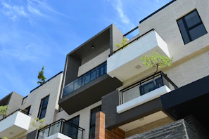 Contemporary facade of Kripa Elite Shraddha complex with clear blue sky backdrop.