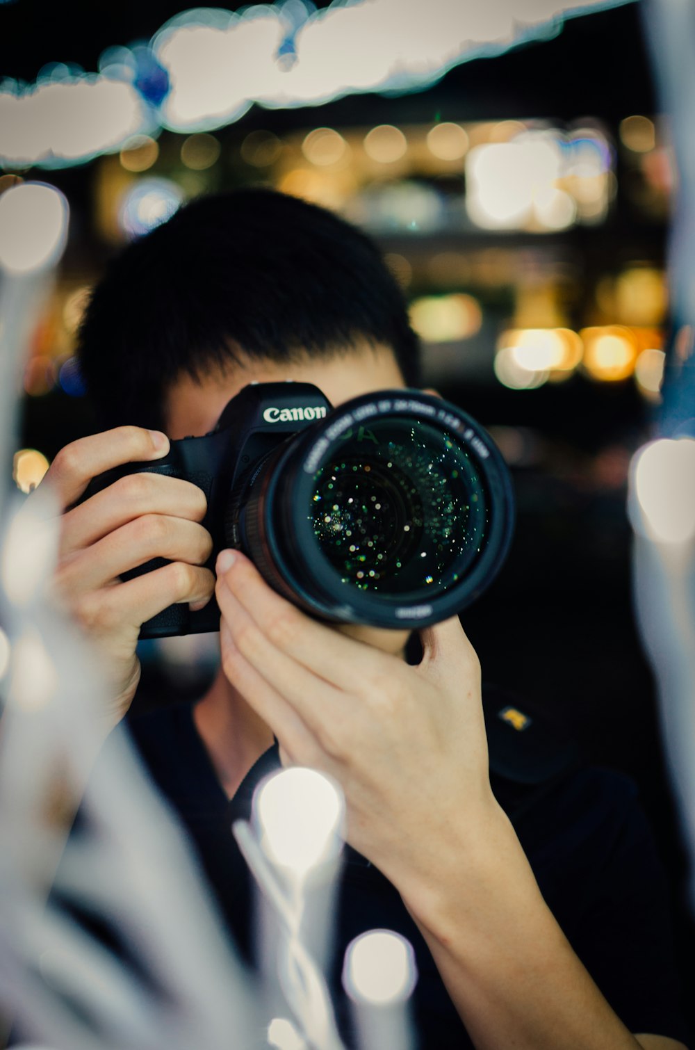 person using black Canon DSLR camera