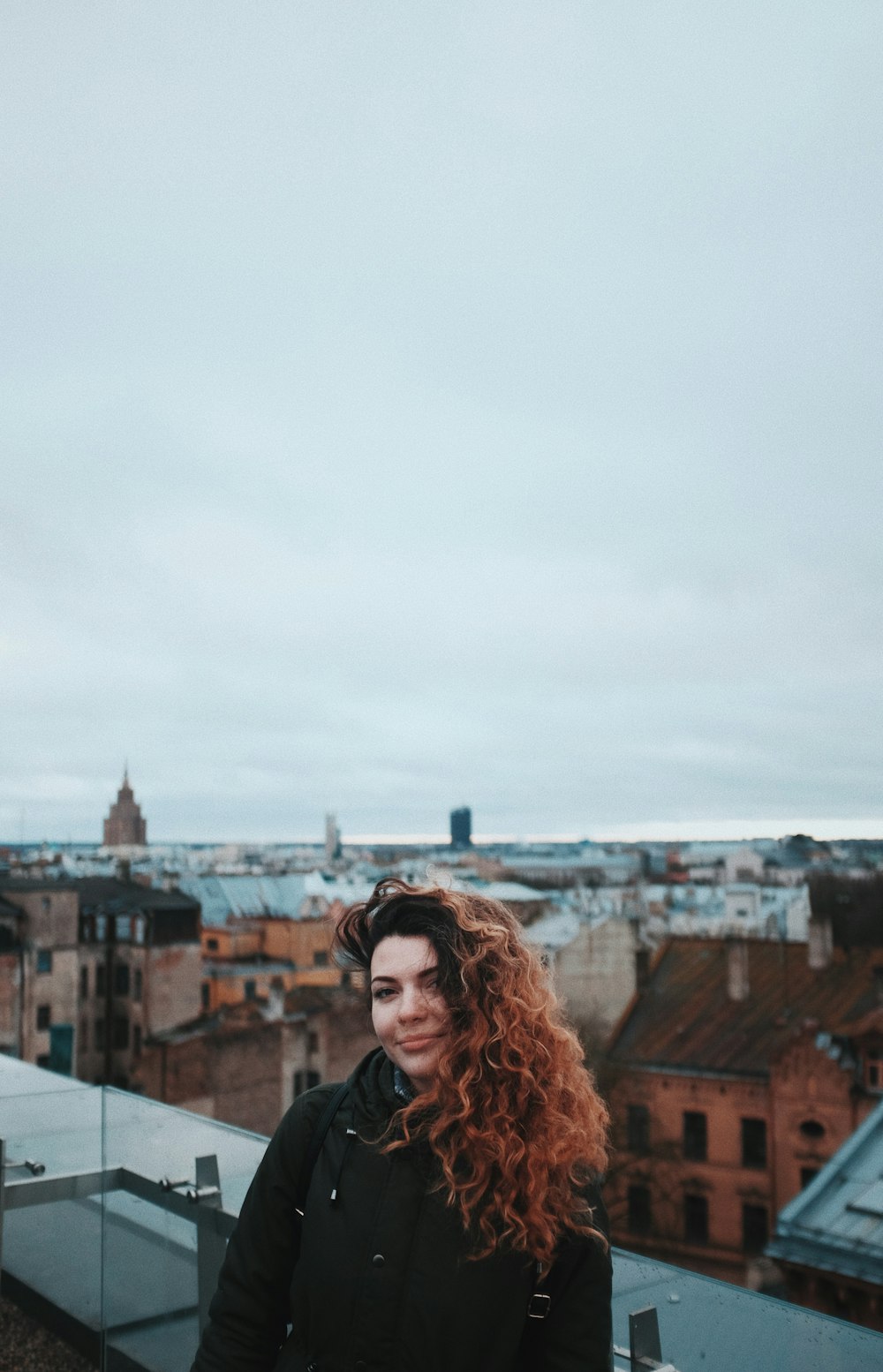 woman leaning on grass fence during dawn