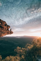man sitting on mountain rock