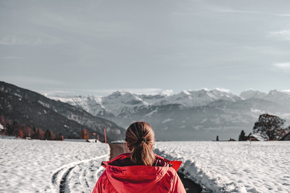 woman wearing red hoodie standing on snow