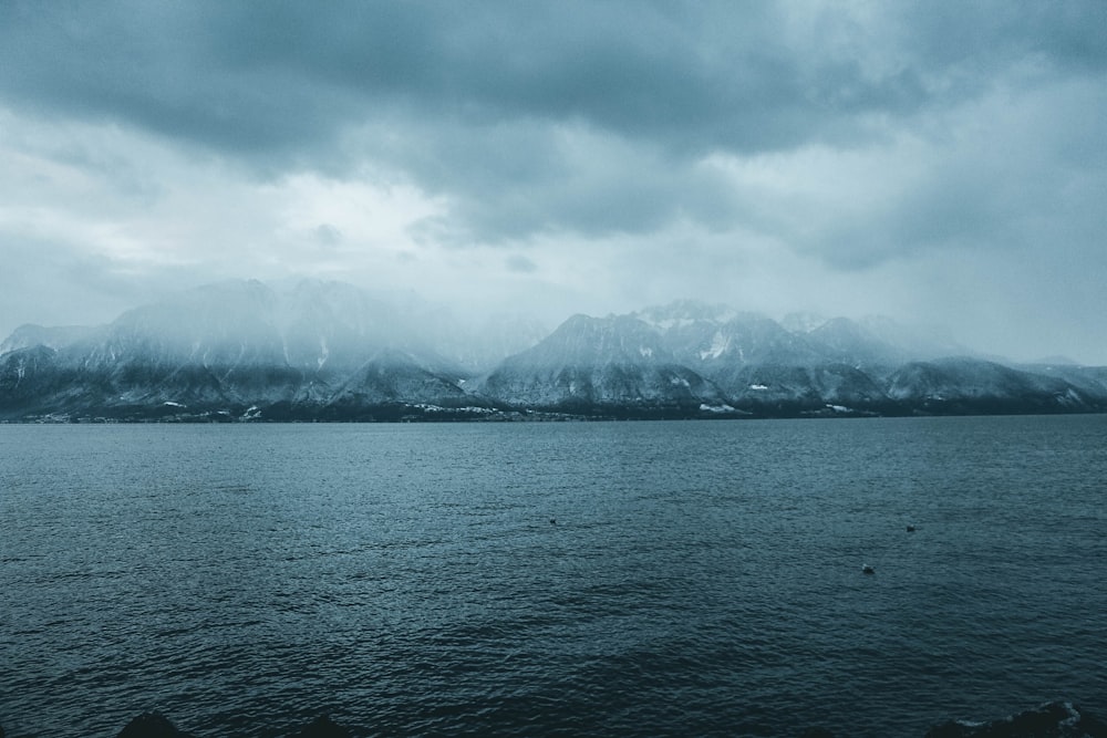 rocky mountain near body of water