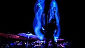 An elegant corporate party with theatrical lighting and guests enjoying a dynamic performance.