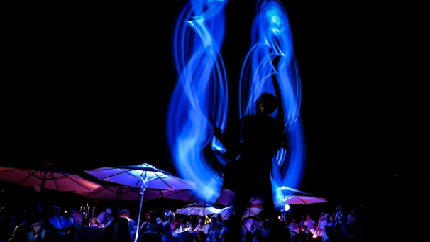 An elegant corporate party with theatrical lighting and guests enjoying a dynamic performance.
