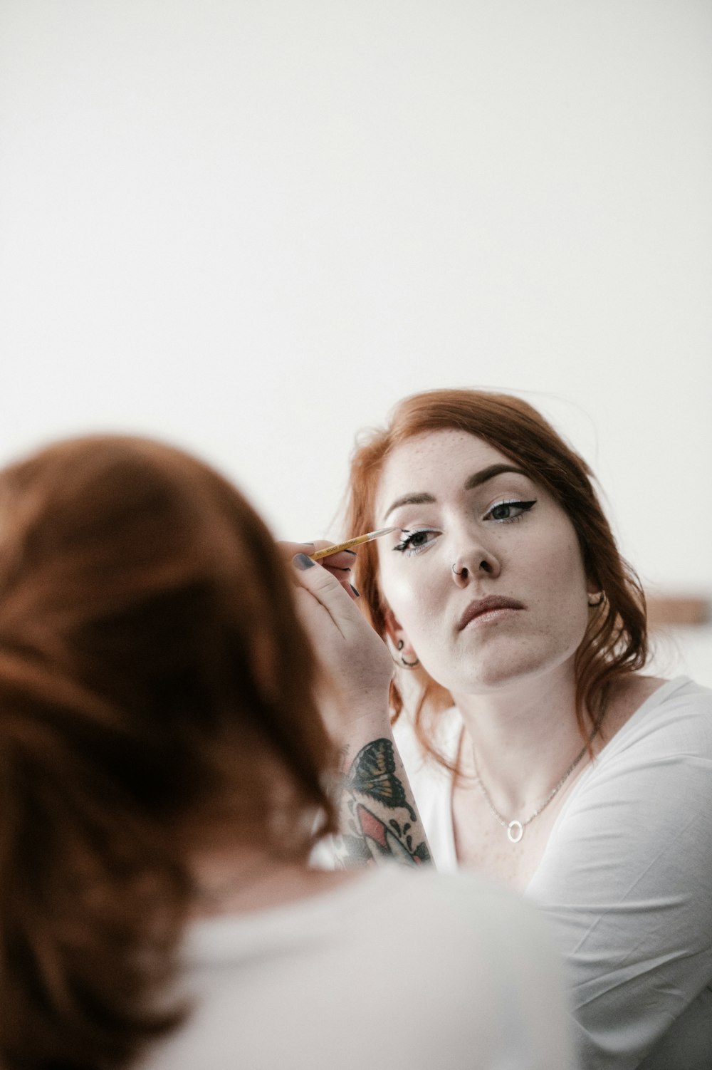 woman putting on liquid eyeliner