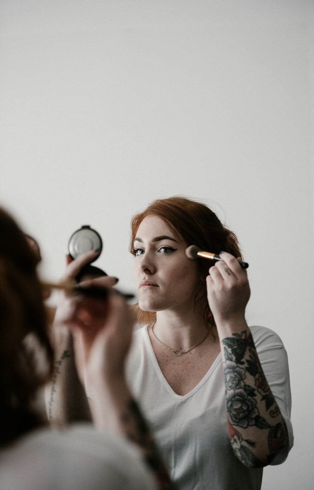 woman putting foundation on face