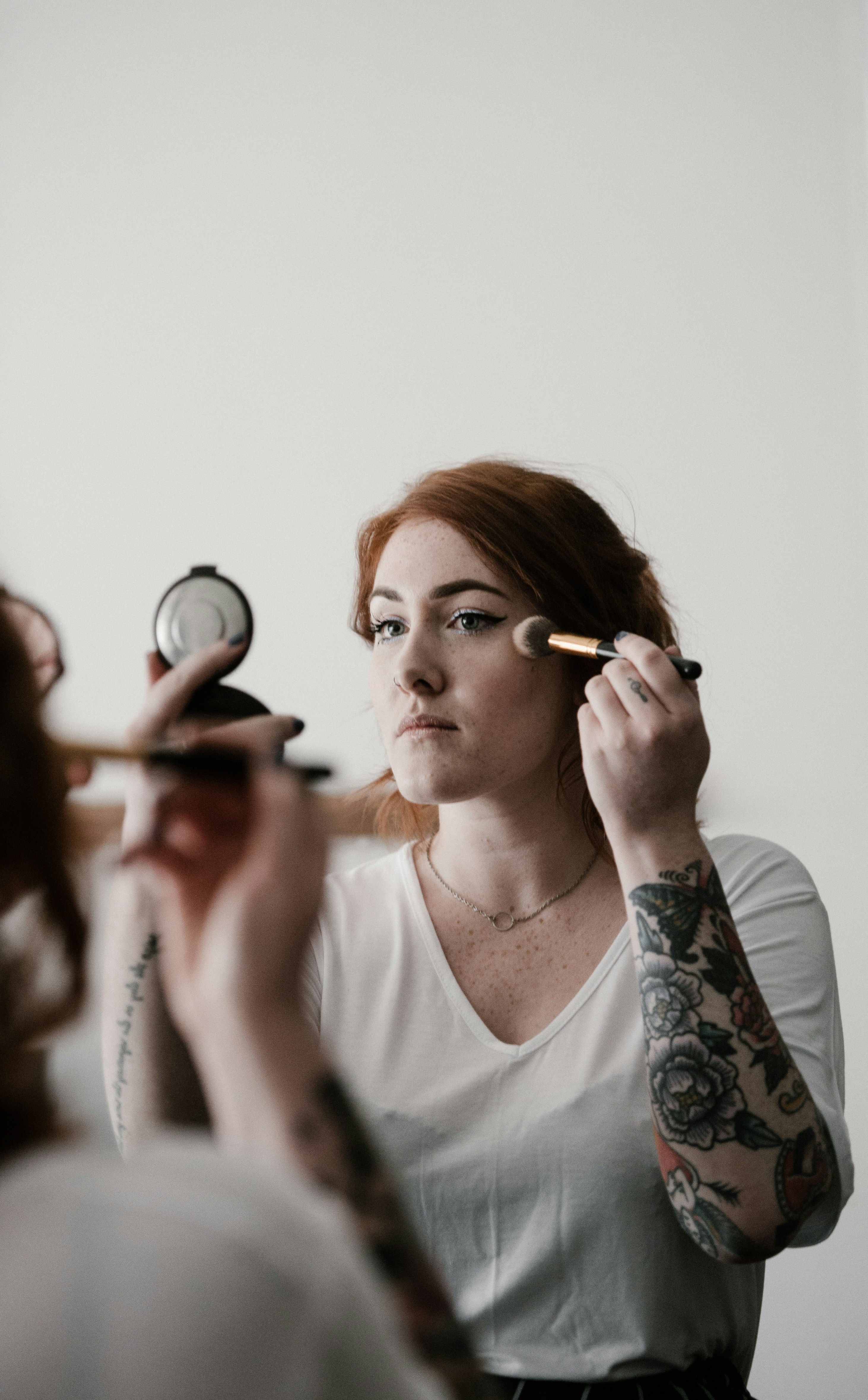 Woman applying blusher / highlighter, make up