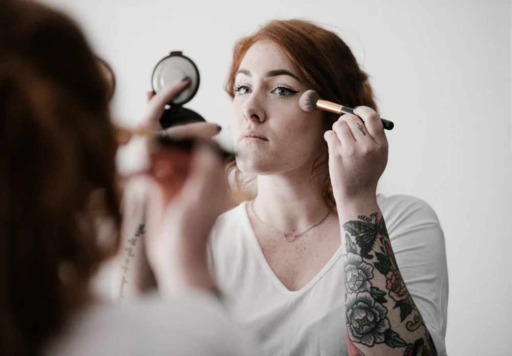 Makeup artist applying blush during a makeup session