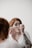 woman using makeup during daytime