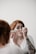 woman using makeup during daytime